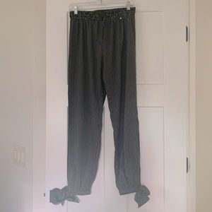 Slim cut pants with slit on each side that runs mid calf to ankle